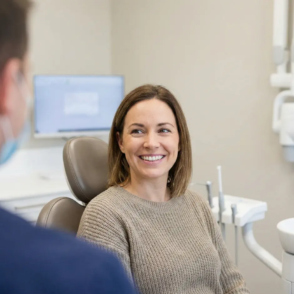 Patient smiling in the dental chair during a clear aligner visit at Premier Dentistry