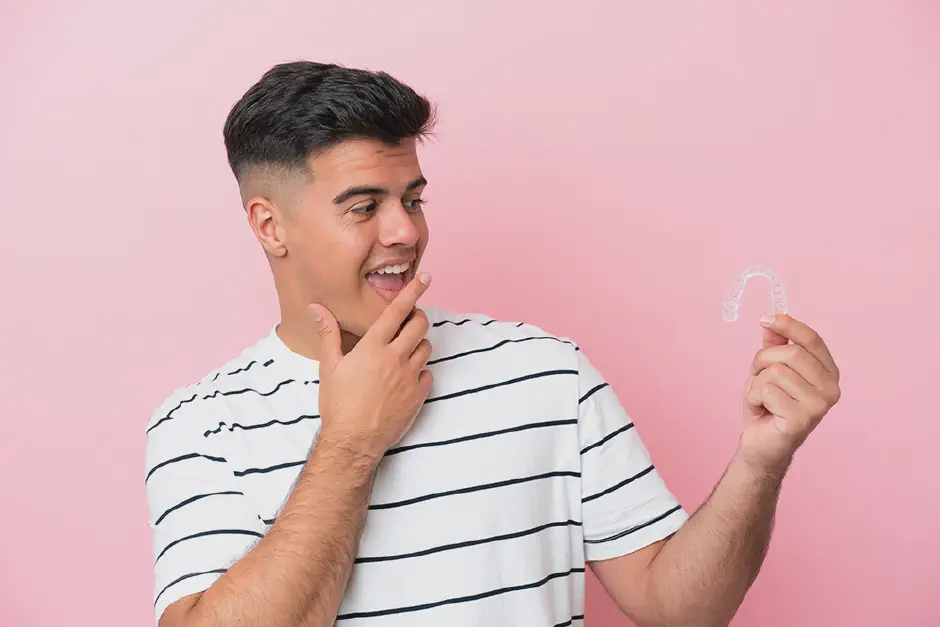 A happy adult patient wearing clear aligners
