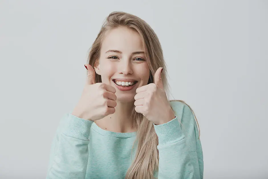 A happy teen girl wearing clear aligners