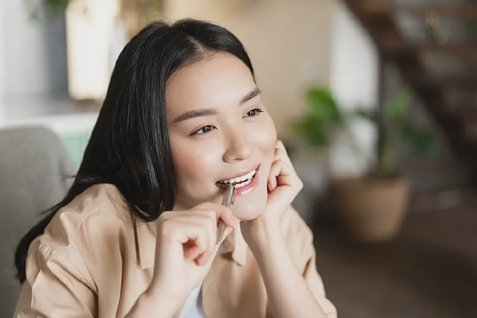 A thoughtful teen girl thinking about clear aligners