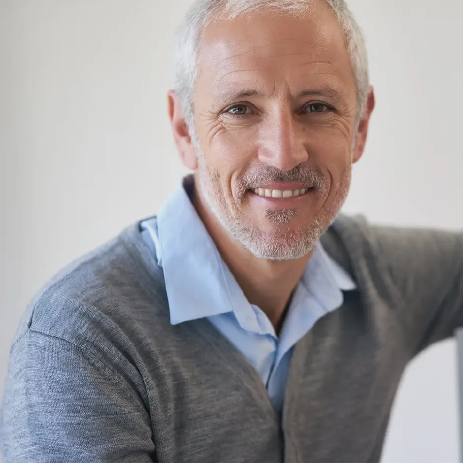 laid back confident portrait mature businessman happy about his dental implant