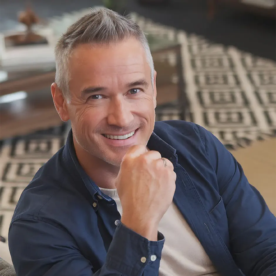 smiling mature man sitting couch posing