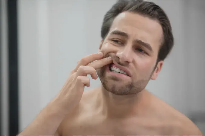 A guy checking his teeth
