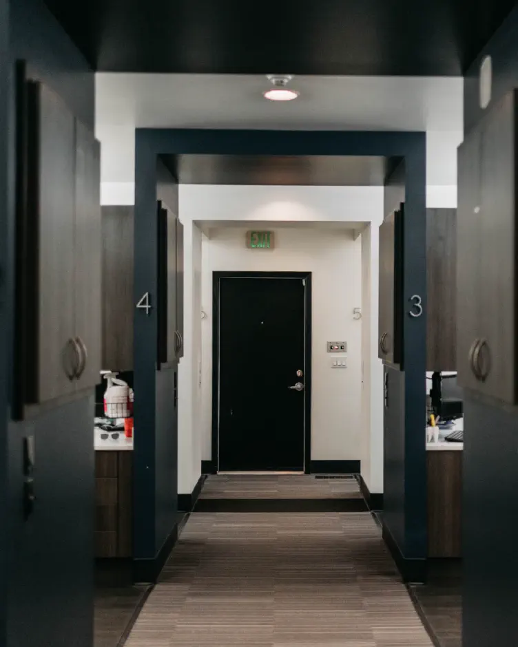 Hallway of numbered treatment rooms at Premier Dentistry in Gresham, OR