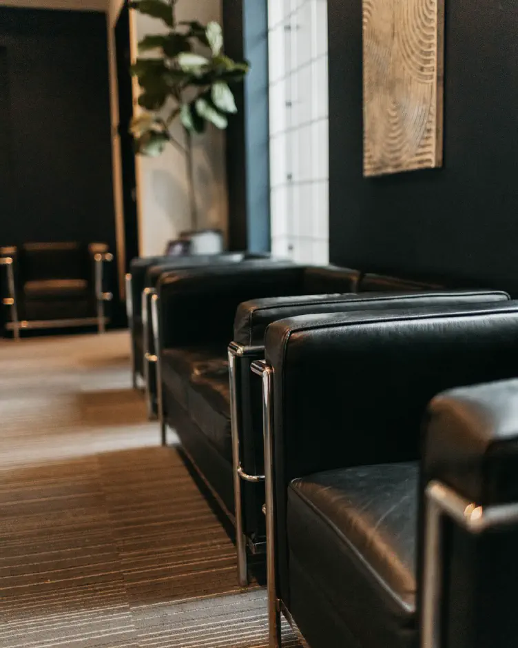 Black leather chairs in the waiting room at Premier Dentistry in Gresham, OR