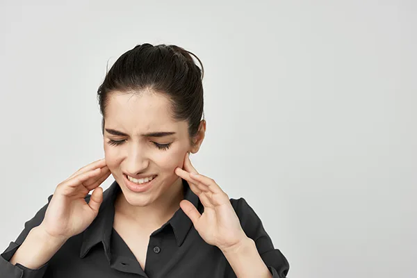 Brunette holding her head depressed isolated background